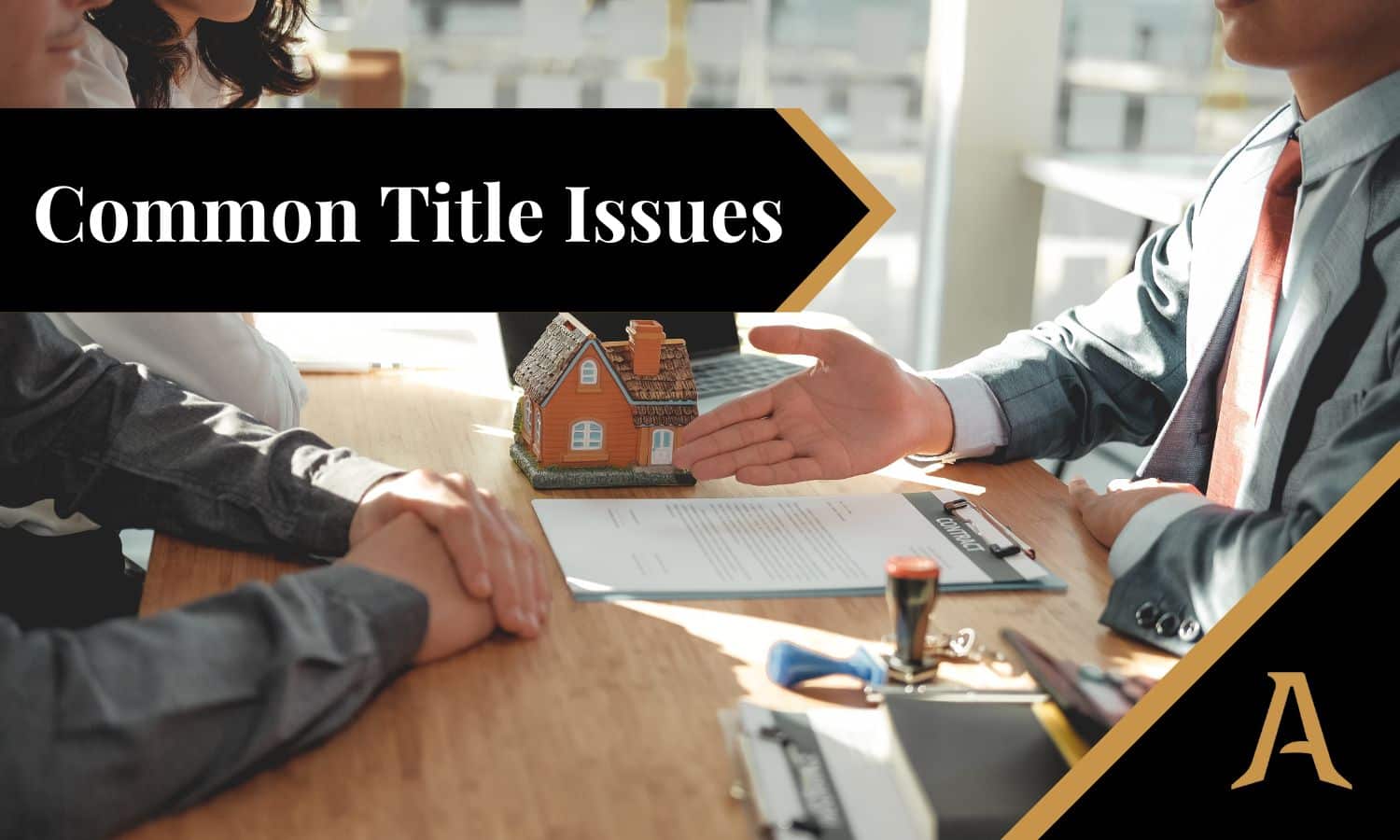 Business meeting with a small model house on the table, with the words 'Common Title Issues' displayed prominently on a black banner.